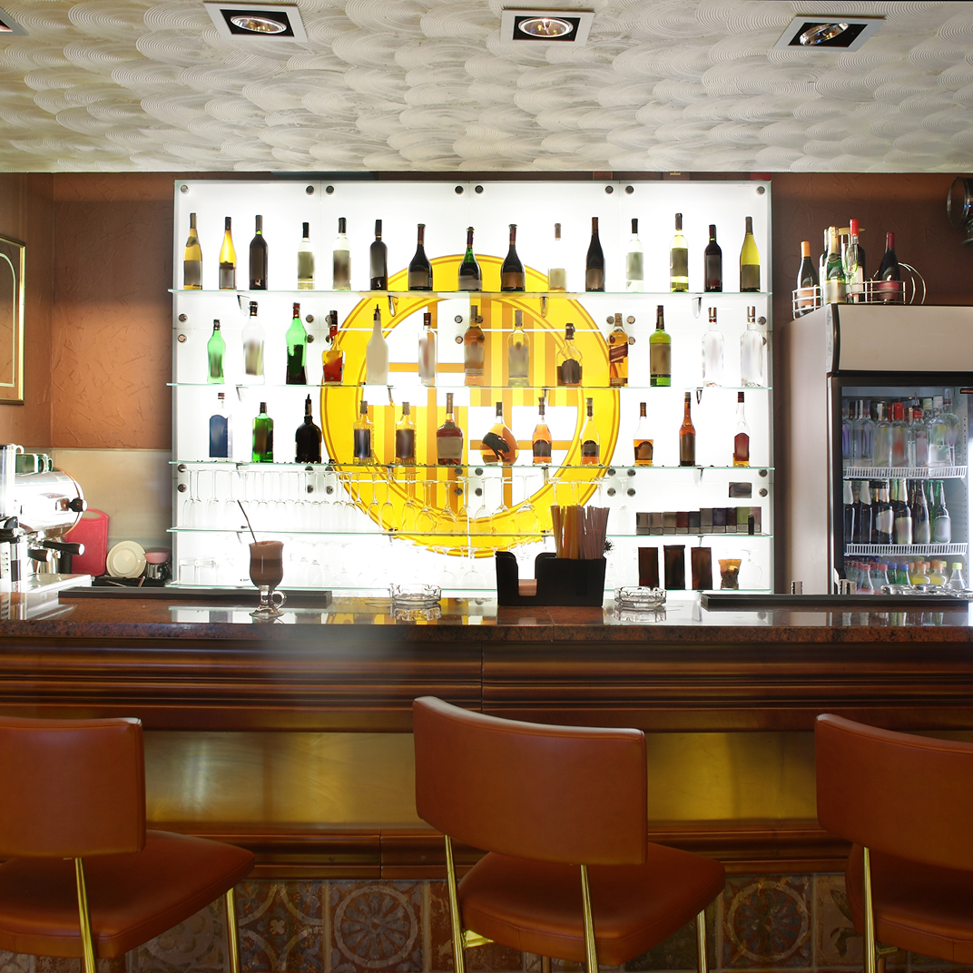 listing1 Bar with bottles and leather chairs.