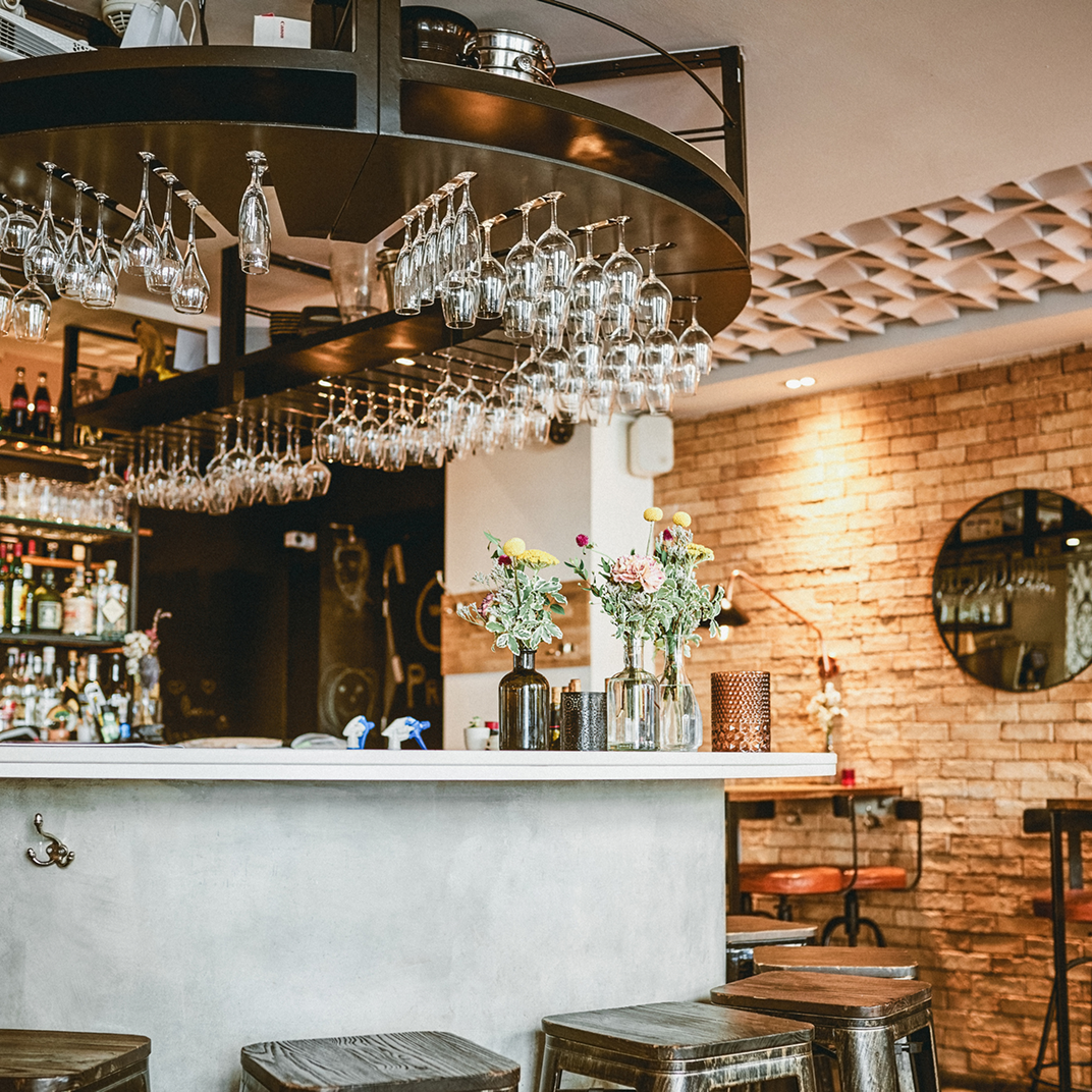 listing2 Cozy bar interior with hanging glasses.