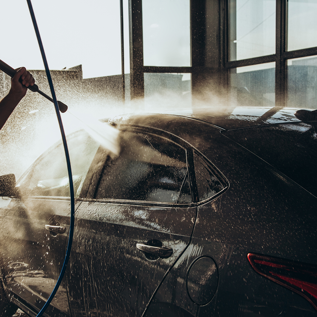 listing4 Person washing car with high-pressure hose.