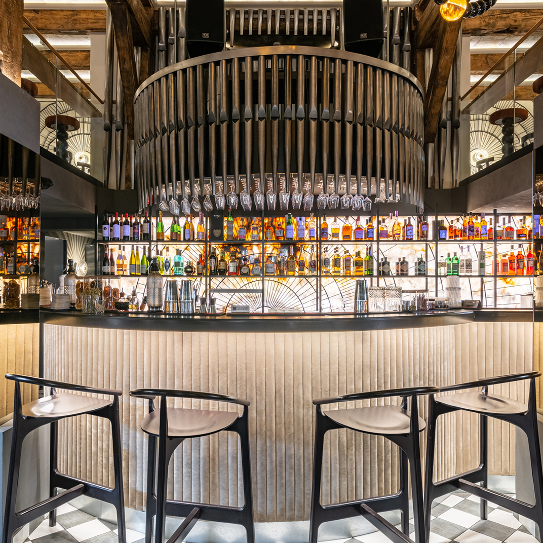 listing8 Modern bar interior with hanging glasses display.
