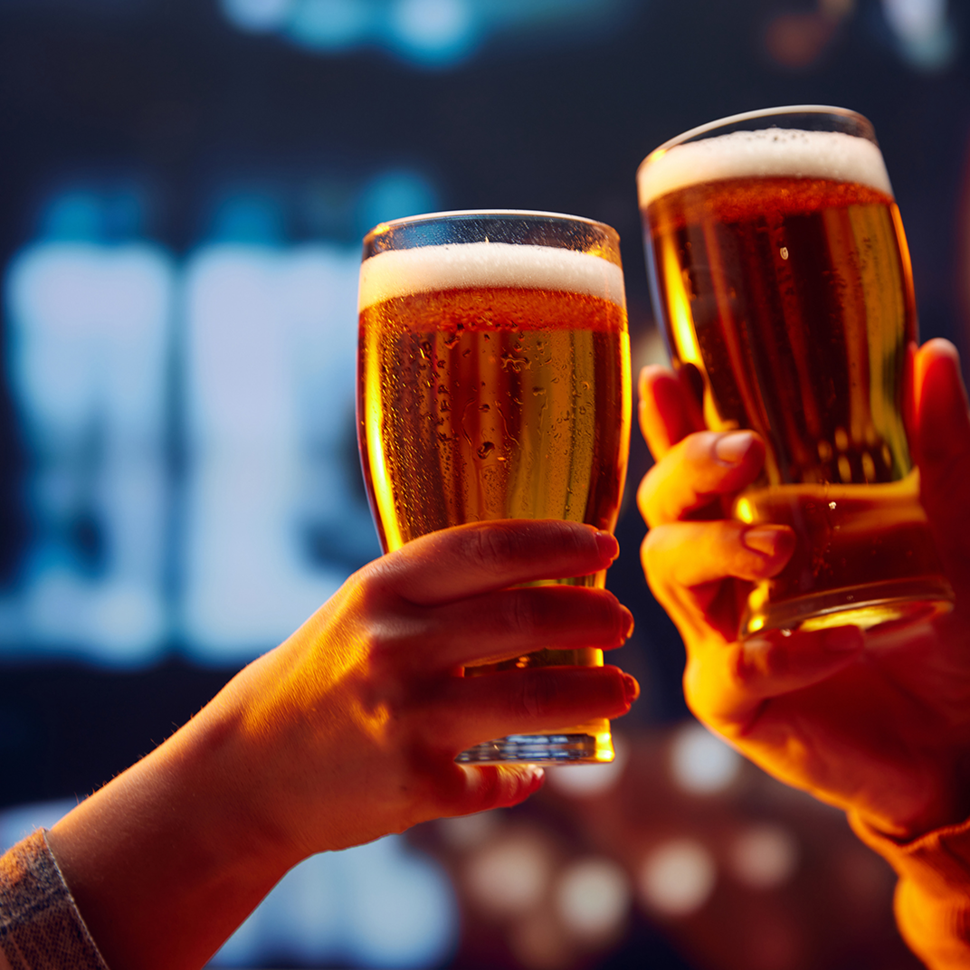 listing9 Two hands clinking beer glasses together.